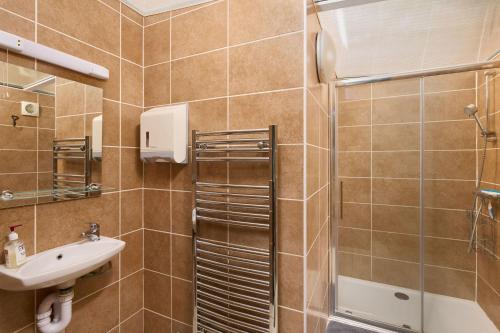 a bathroom with a shower and a sink at Allercombe Farm Glamping Yurts & Wild Camping in South Brent