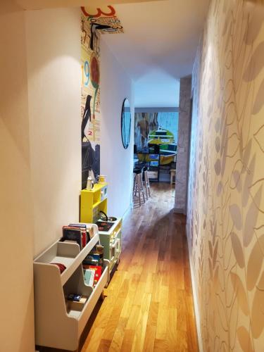 a room with a hallway with a table and a chair at Lac Saint-Point au balcon in Malbuisson