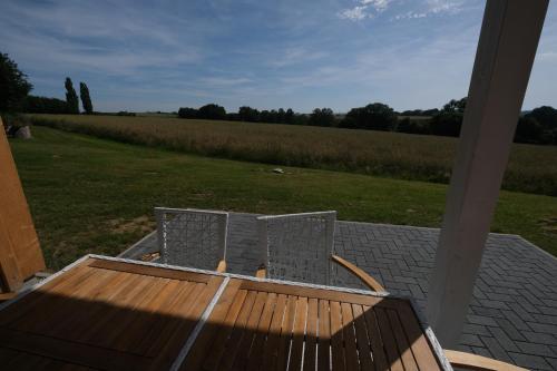 a couple of chairs sitting on a porch with a field at Ferienhaus Landblick in Warstein