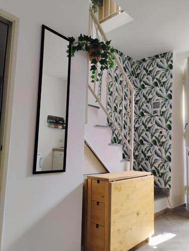 a mirror and a dresser in a hallway with a staircase at Nicaredda in Catania