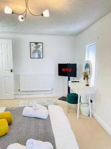 a room with a bed and a desk with a tv at Mount Yard - Stylish Cottage - Close to Alton Towers - Peak District - Stoke-on-Trent Sleeps 5 in Totmonslow