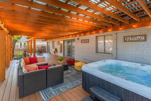 a large hot tub on a deck with a patio at Luxurious Home With Hot Tub & Tree Deck By 6flags in San Antonio