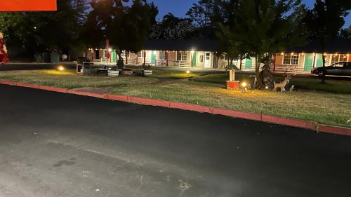 a house with two deer on the side of the road at Jumping Frog Motel in Angels Camp