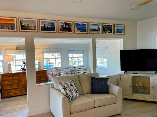 a living room with a couch and a flat screen tv at Kings Kamp in Key Largo