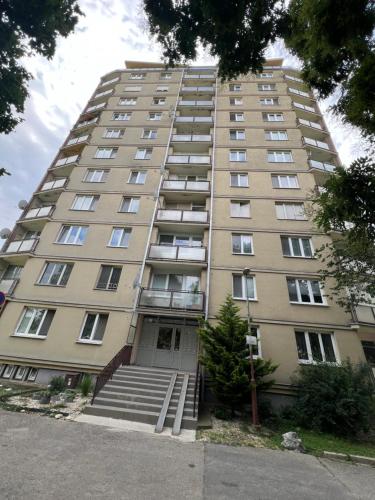 a tall apartment building with stairs in front of it at -Self-check- brand new apartment White-Diamond in Nitra