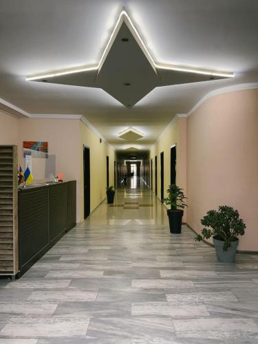 an empty hallway in a building with plants at Hotel Solidarity in K'obulet'i