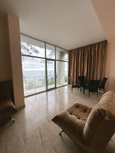 a living room with a couch and a table at Hotel Solidarity in K'obulet'i