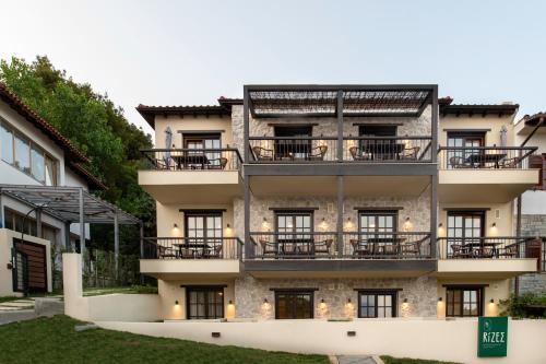 an exterior view of a building with balconies at RiZEΣ in Ouranoupoli