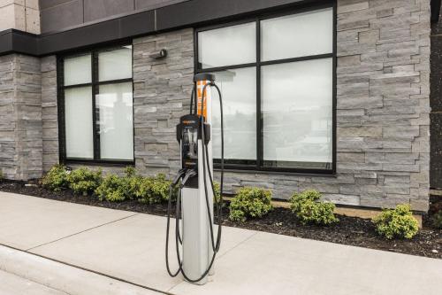a parking meter on a sidewalk in front of a building at Holiday Inn Express & Suites Toronto Airport South by IHG in Toronto