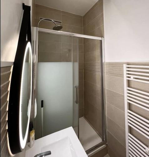 une salle de bain avec une douche, un lavabo et un miroir dans l'établissement Cozy studio in Saint Germain dès près, à Paris