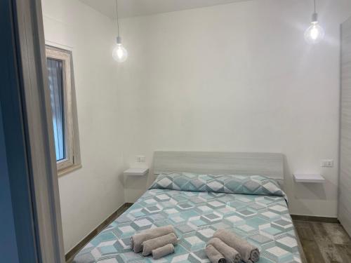 a bedroom with a bed with two towels on it at Muschiaturo in Foce Varano