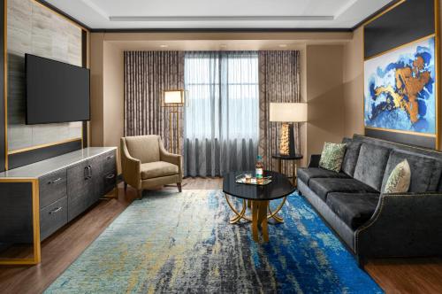 a living room with a couch and a tv at Mount Airy Casino Resort - Adults Only 21 Plus in Mount Pocono