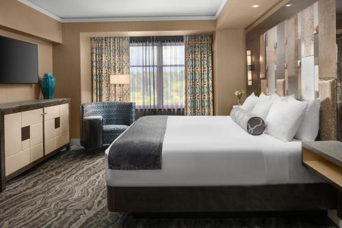 a hotel room with a large bed and a television at Mount Airy Casino Resort - Adults Only 21 Plus in Mount Pocono
