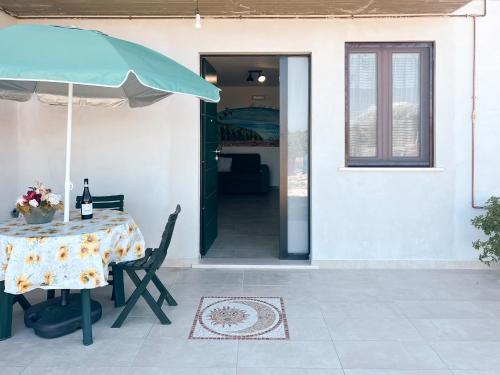 a table and an umbrella on a patio at La Casa Nel Vigneto 2 in San Vito Chietino