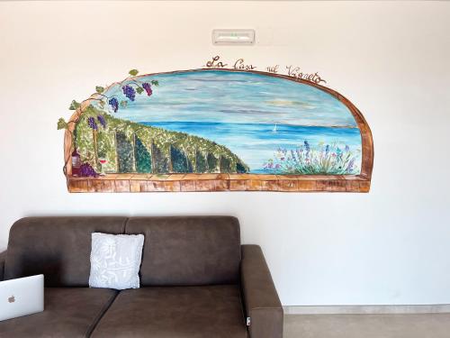a painting on a wall above a couch at La Casa Nel Vigneto 2 in San Vito Chietino