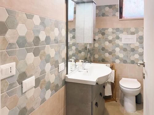 a bathroom with a sink and a toilet at La Casa Nel Vigneto 2 in San Vito Chietino