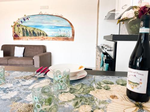 a table with a bottle of wine and a glass at La Casa Nel Vigneto 2 in San Vito Chietino