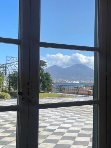 a window looking out at a view of the ocean at Casetta Piazza Plebiscito in Naples