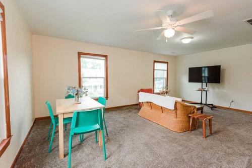 a living room with a table and chairs and a couch at Kinston Getaway #2 in Kinston