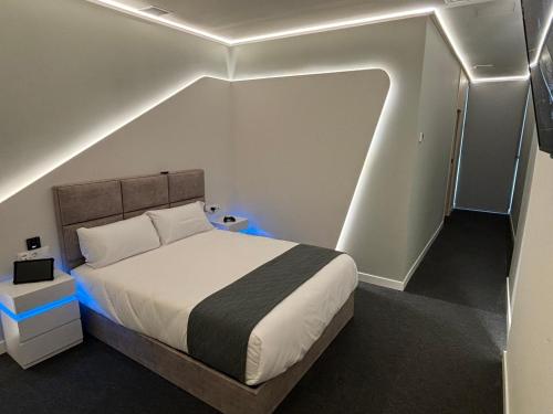 a bedroom with a bed in a room with lights at Futurotel Sevilla in Seville