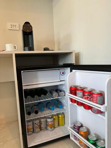 an open refrigerator filled with lots of food and drinks at Pousada Fast Inn in Guarujá