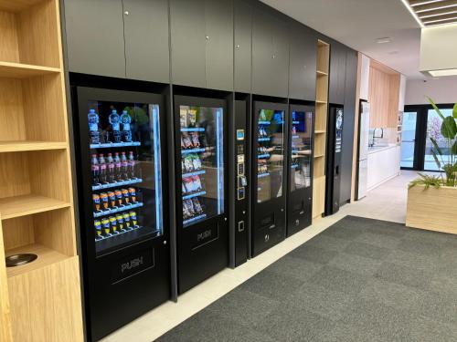 a row of soda vending machines in a office building at Futurotel Sevilla in Seville