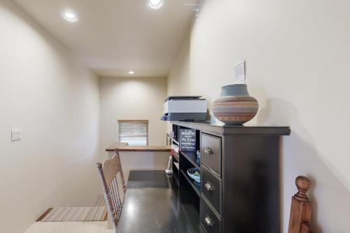 a room with a black cabinet with a vase on it at Susan's Hideaway Unit B in Santa Fe