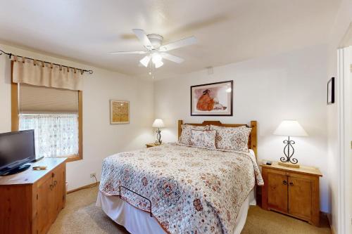 a bedroom with a bed and a ceiling fan at Ciclo Grande 202B in Santa Fe