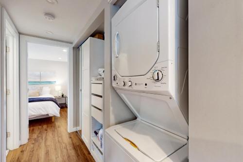 a white refrigerator in a room with a bedroom at Queen Anne Escape in Seattle