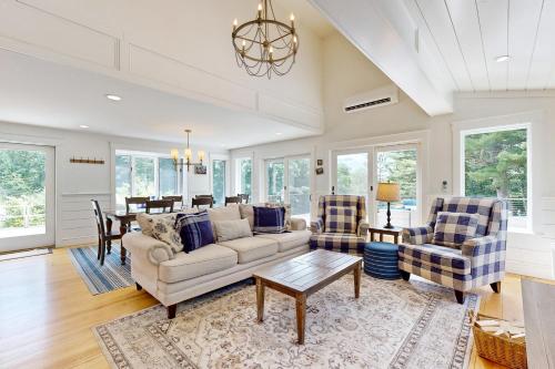 a living room with a couch and chairs and a table at Newcastle Lake House in Newcastle