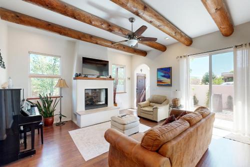 a living room with a couch and a fireplace at Shalako Adventures in Santa Fe