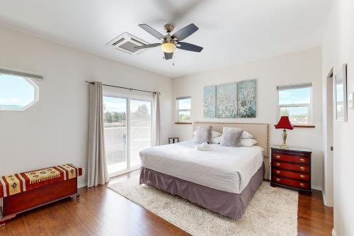 a bedroom with a bed and a ceiling fan at Shalako Adventures in Santa Fe