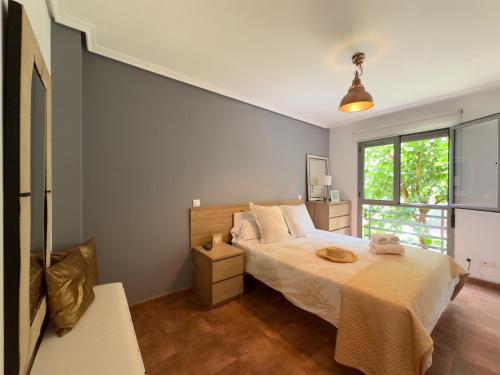 a bedroom with a bed and a window at La Ensenada de Meruelo - 2805 in San Miguel de Meruelo