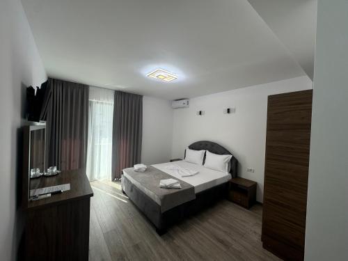 a hotel room with a bed and a window at Casa Cristal Sulina in Sulina