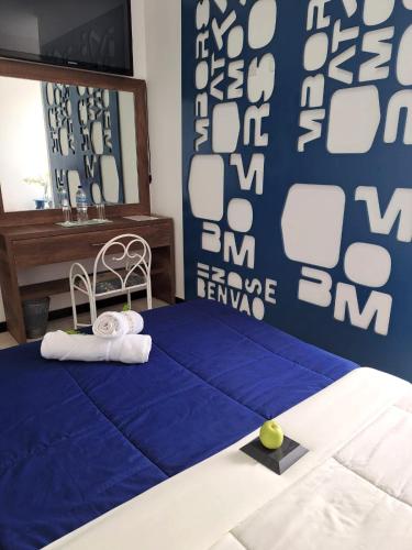 a bedroom with a blue and white wall at HOTEL BOUTIQUE KRYSTAL in Quito