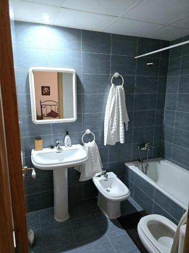 a bathroom with a sink and a toilet and a tub at Maestrat13 in Peñíscola