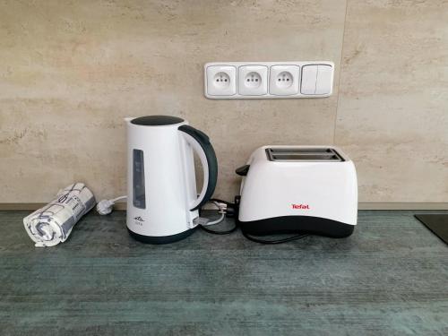 a coffee maker and toaster sitting on a counter at Garden apartment RELAX in Doksy