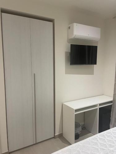 a bedroom with a white closet and a white desk at maraneri rooms in Bovalino Marina