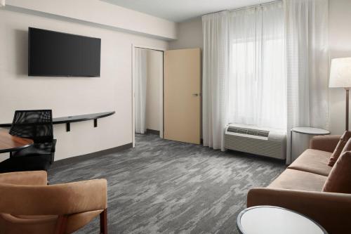 a living room with a couch and a table at Fairfield Inn & Suites Columbus OSU in Columbus