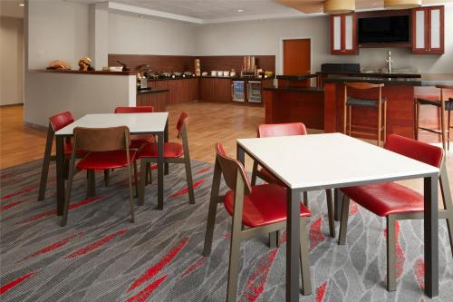 a kitchen and dining room with tables and chairs at Fairfield Inn & Suites Columbus OSU in Columbus