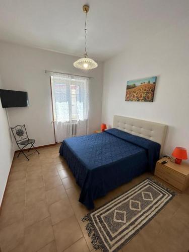 a bedroom with a blue bed and a rug at Casa Vacanza SOFIA in Ravello