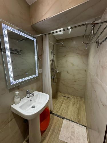a bathroom with a sink and a mirror at Villa Shpetim Zogaj. in Ksamil