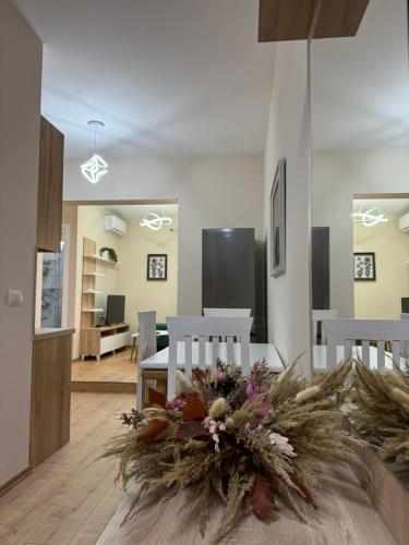 a living room with a table with a flower arrangement on it at Haris Apartments Tirana in Tirana