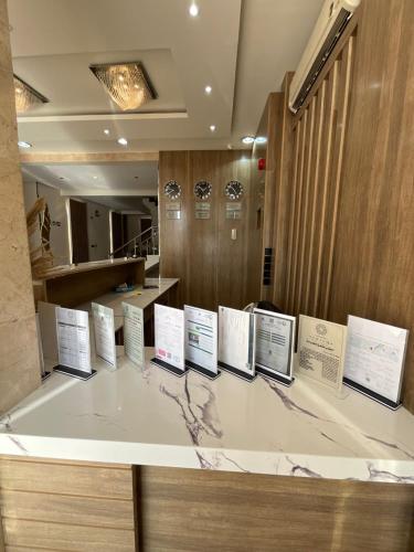 a display of signs on a counter in a room at تاج الملقي للشقق المخدومة in Hail
