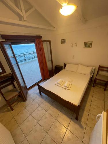 a bedroom with a bed with a view of the ocean at Delfinia Studios in Platanias