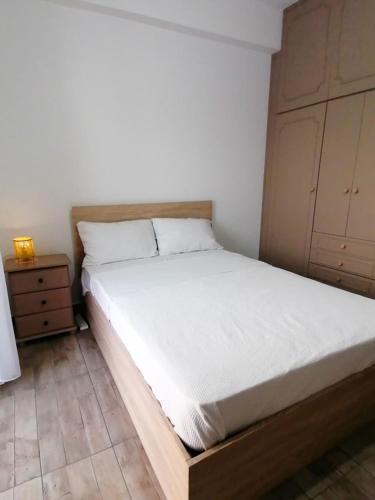 a bedroom with a bed and a night stand at The Host - Women and couples only in Paphos City