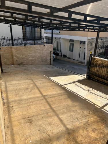 an empty parking lot in a building with a metal roof at City Heart Apartments in Ulcinj