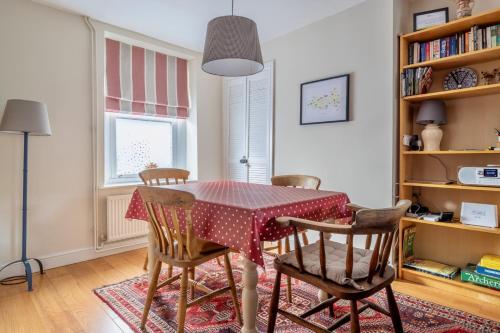 a dining room with a table and chairs at Chic 2-bedroom townhouse in vibrant Abergavenny in Abergavenny