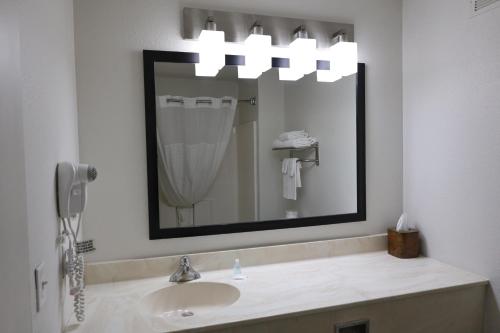 a bathroom with a sink and a mirror at MainStay Suites Madison Airport in Madison