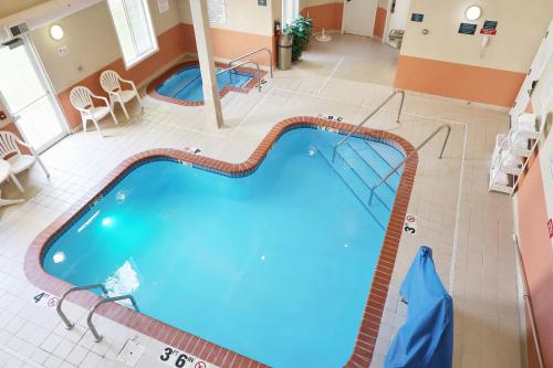 an overhead view of a large swimming pool in a hotel room at MainStay Suites Madison Airport in Madison
